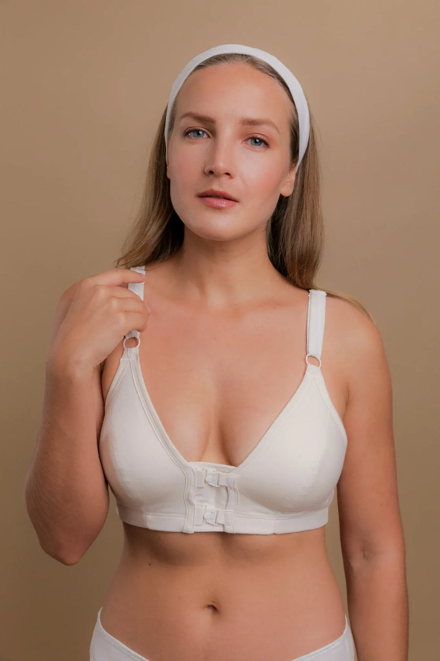 Woman wearing a white front-closure organic cotton bra for sensitive skin