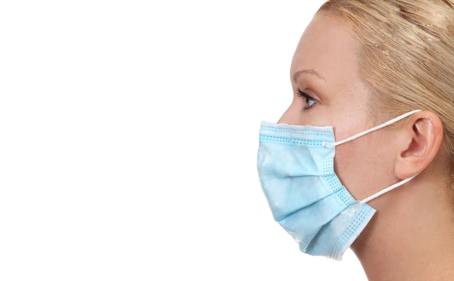 Woman wearing blue disposable face mask for sensitive skin on white background