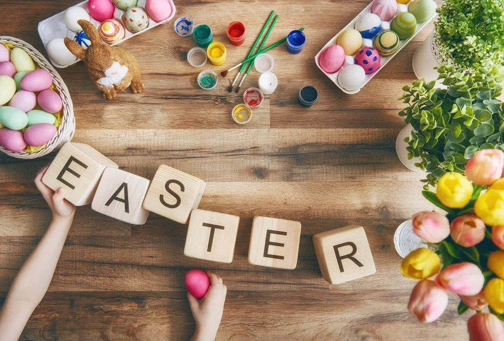 Easter eggs painting set with wooden blocks spelling EASTER, flowers, and spring décor