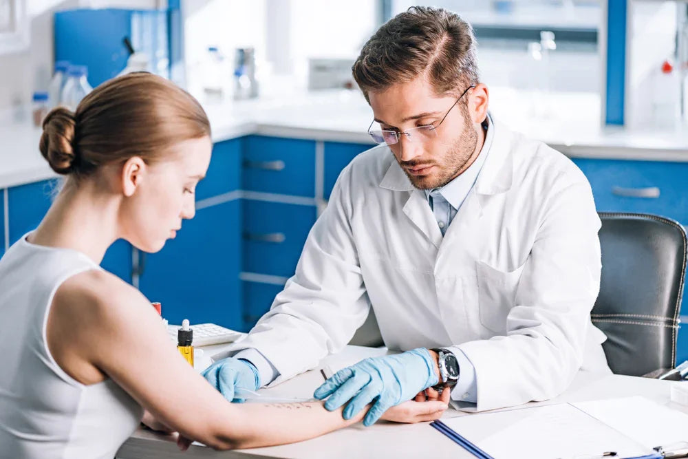 Doctor performing allergy test on woman's arm in a clinic, hypoallergenic care concept