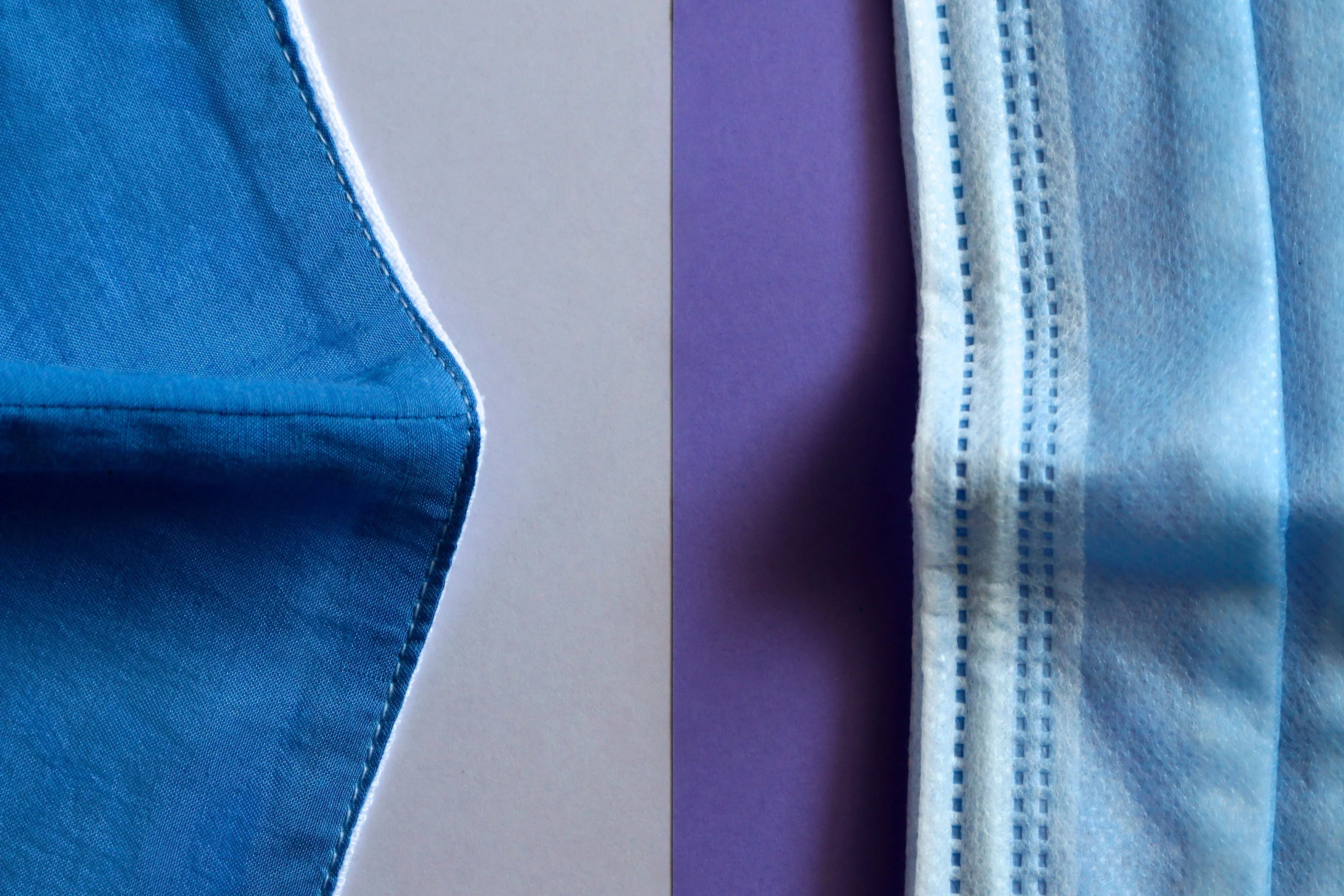 Close-up comparison of blue cotton hypoallergenic mask and blue surgical mask on split background