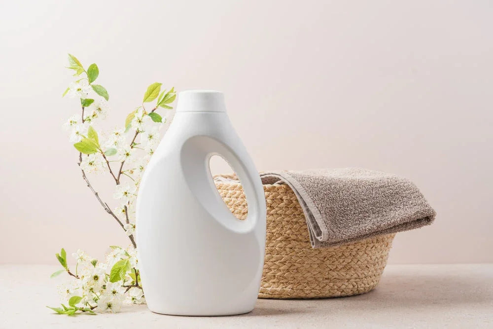 Hypoallergenic laundry detergent bottle, soft towel, and woven basket with flowers