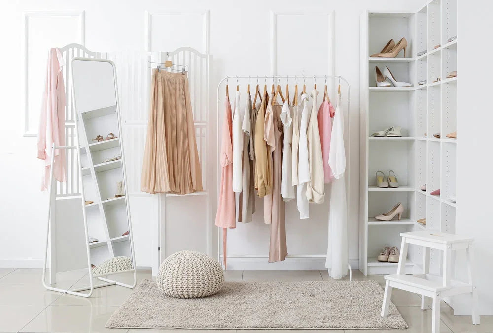 Minimalist closet with allergy-free cotton apparel in neutral tones on racks and shelves