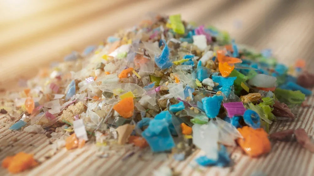 Pile of colorful microplastics on fabric highlighting allergy-free apparel concerns
