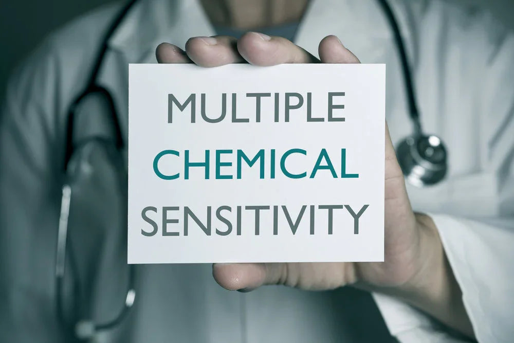 Doctor holding sign reading 'Multiple Chemical Sensitivity,' health and allergy awareness concept