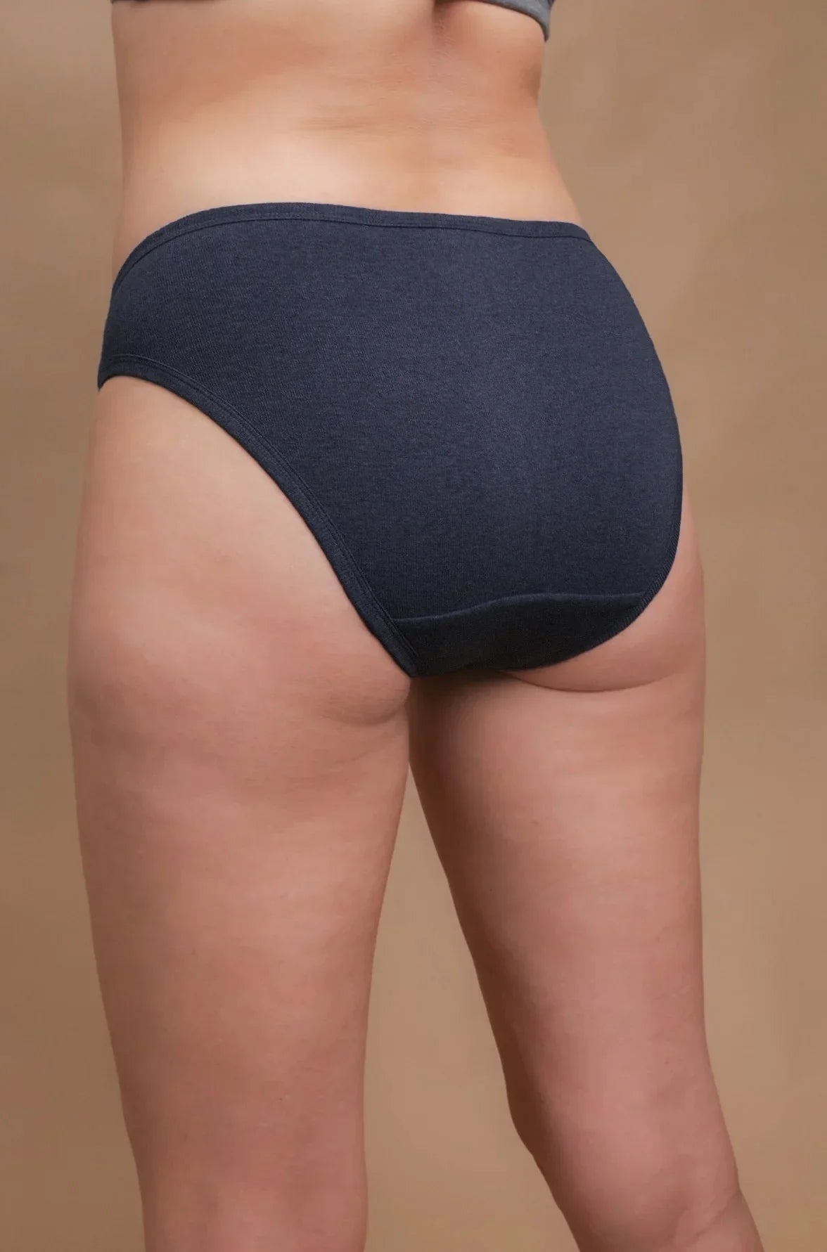 Back view of woman wearing dark blue hypoallergenic cotton underwear from Cottonique