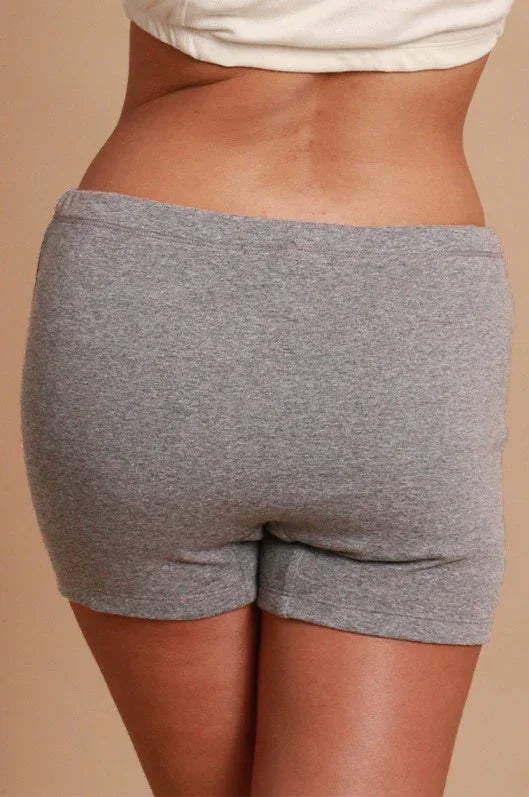 Back view of a person wearing gray hypoallergenic cotton shorts, Cottonique allergy-free apparel