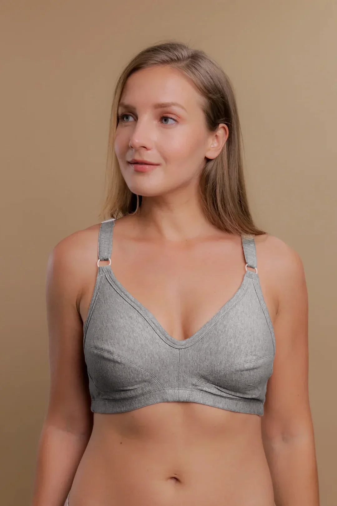 Woman wearing a light grey, wire-free organic cotton bra for sensitive skin