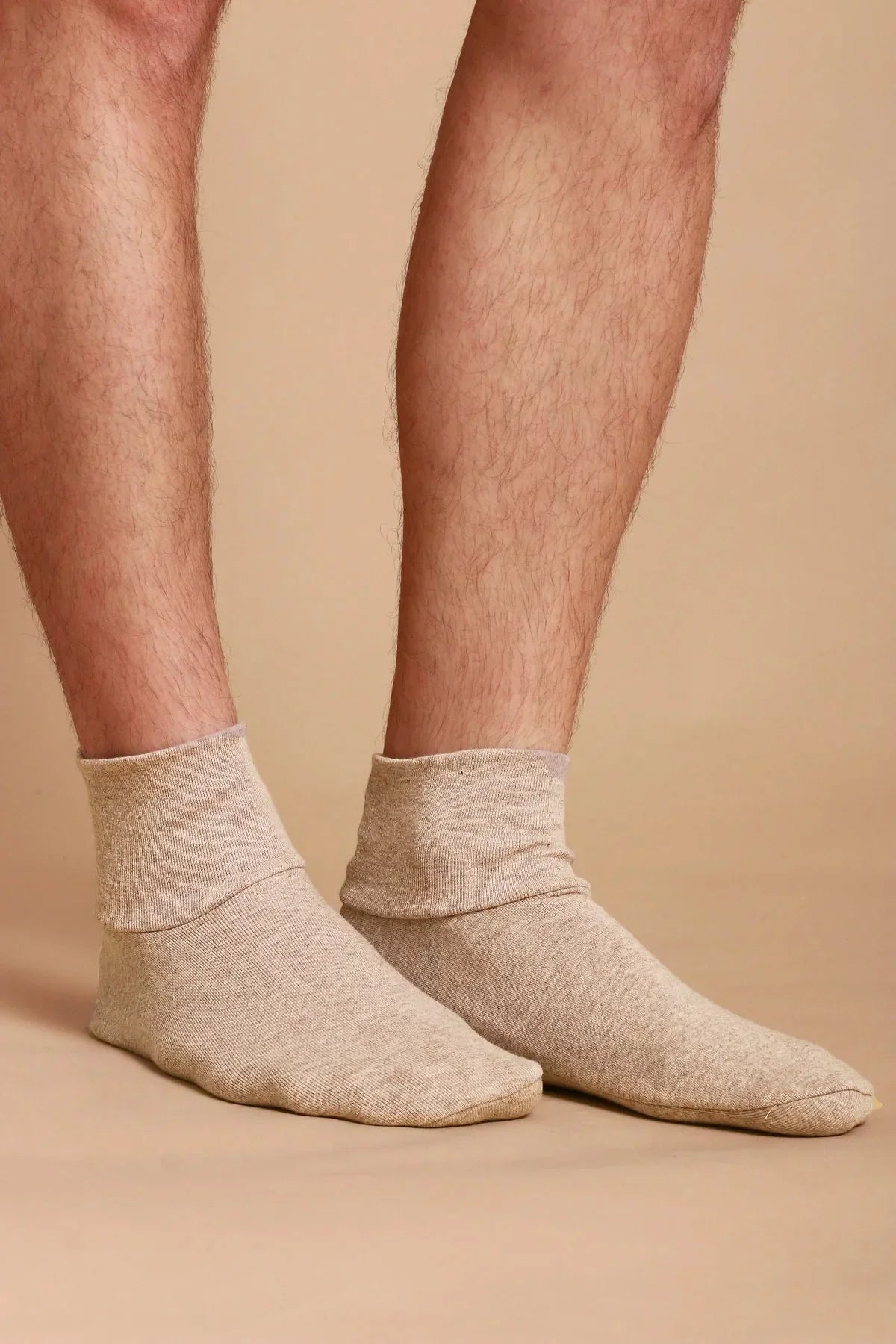 Allergy-free cotton socks on feet, neutral background, Cottonique hypoallergenic apparel