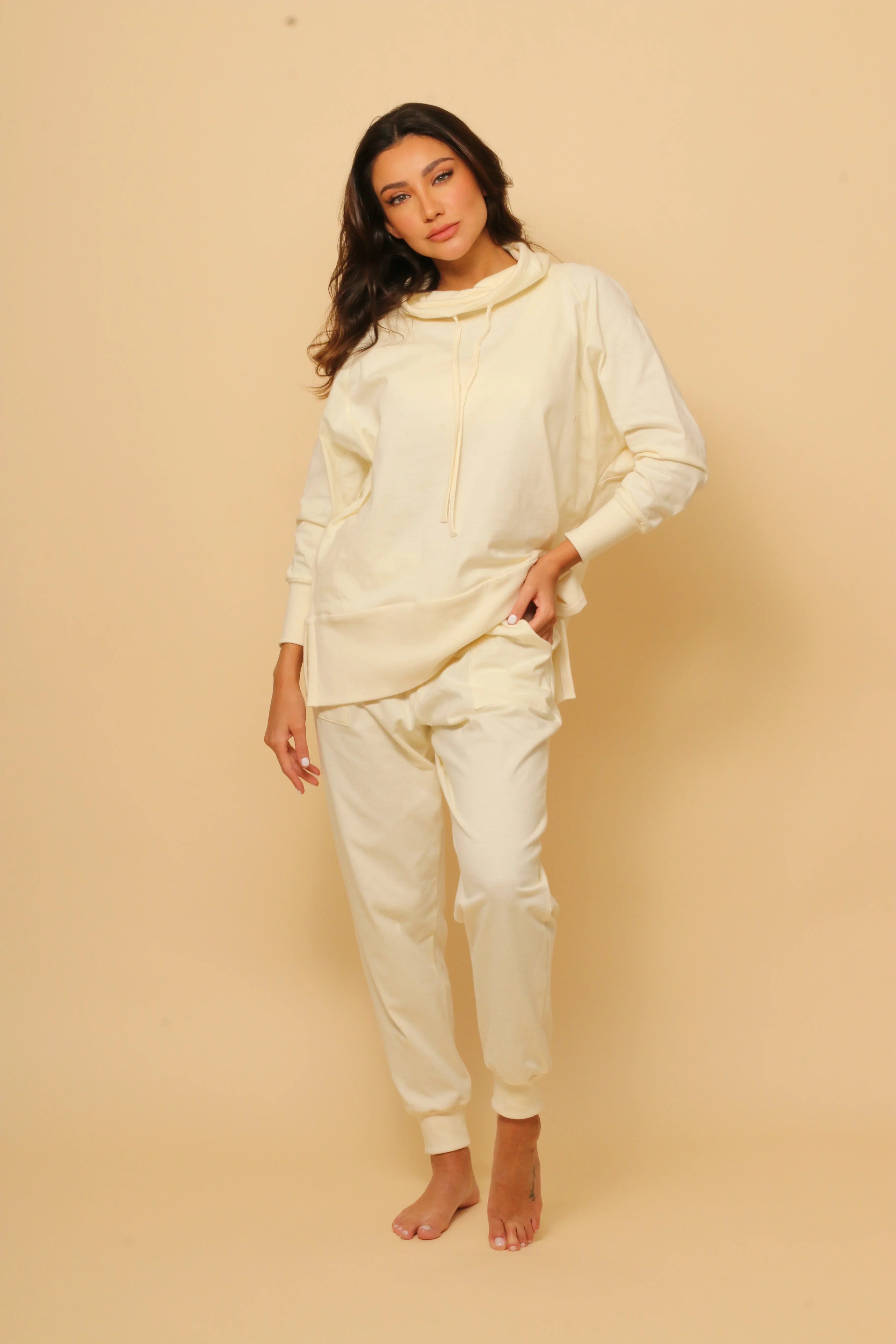 Woman modeling Cottonique allergy-free hypoallergenic lounge set in light beige