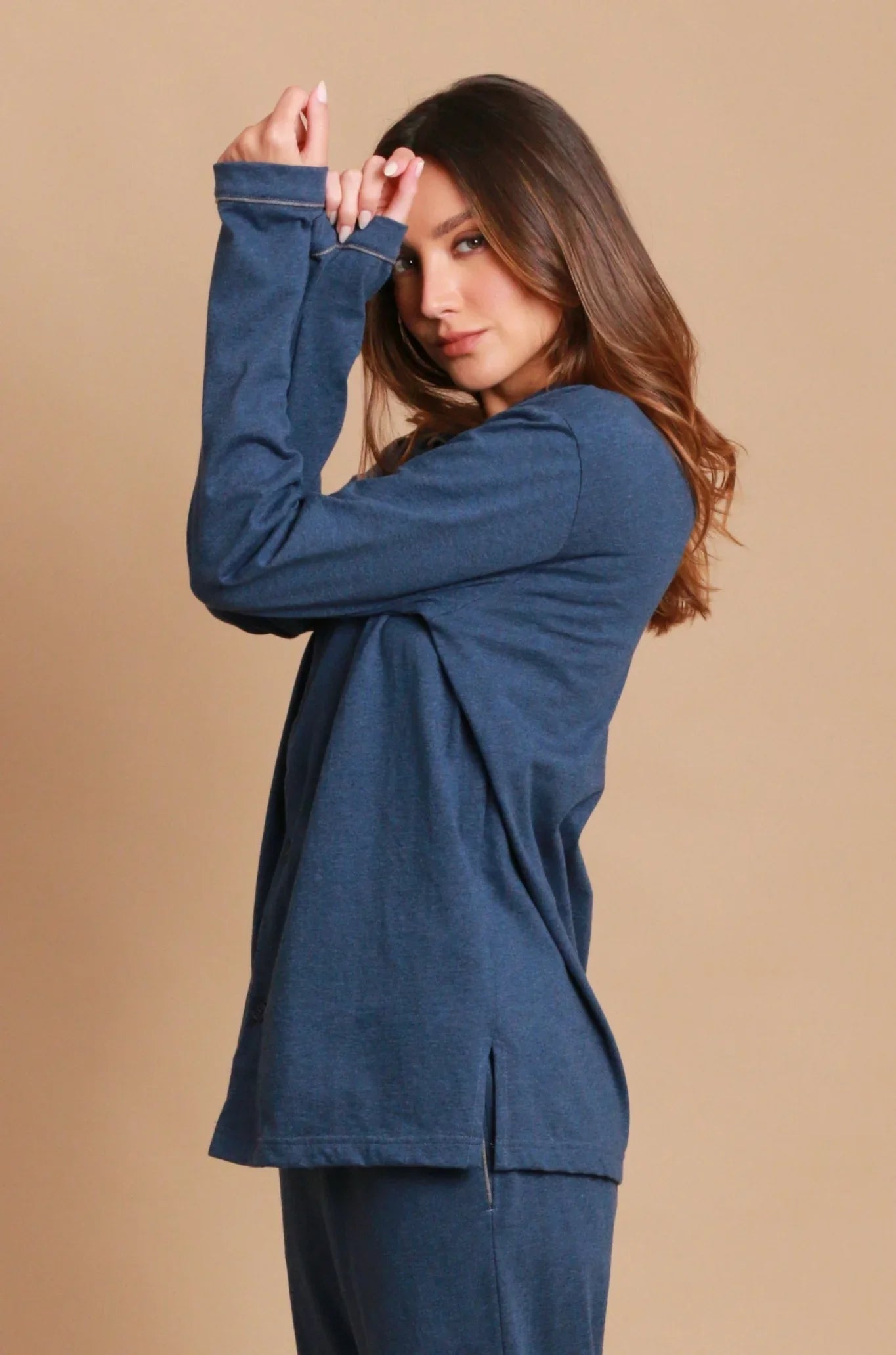 Woman wearing blue hypoallergenic Cottonique shirt and pants on neutral background