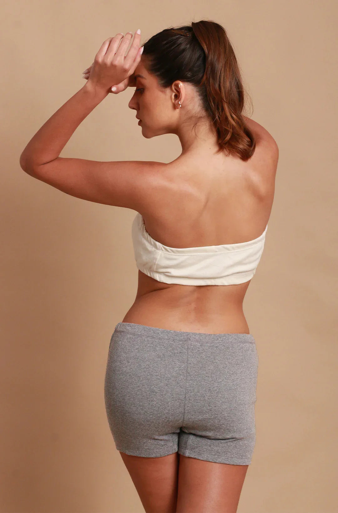Back view of woman in allergy-free organic cotton bandeau and gray shorts