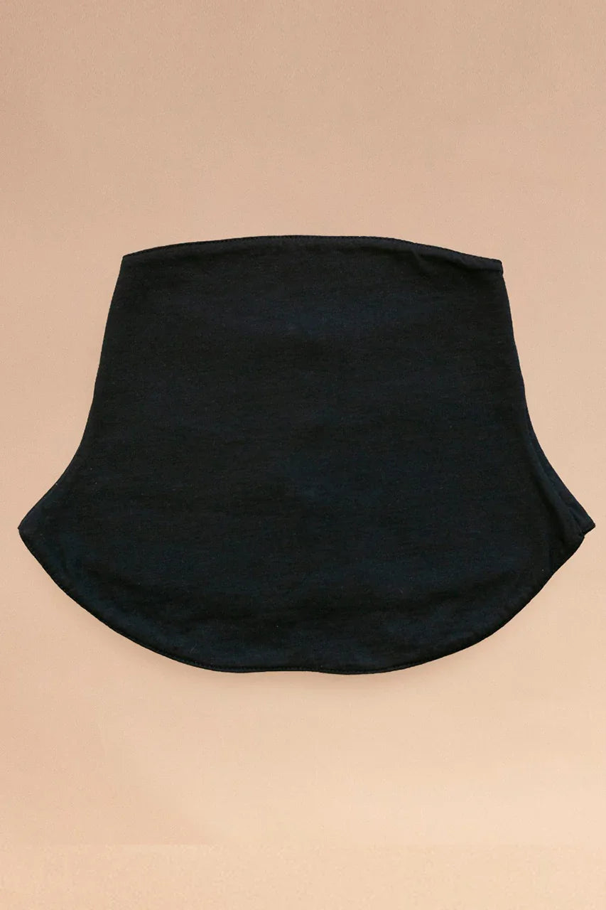 Black organic cotton allergy-friendly neck gaiter laid flat on beige background