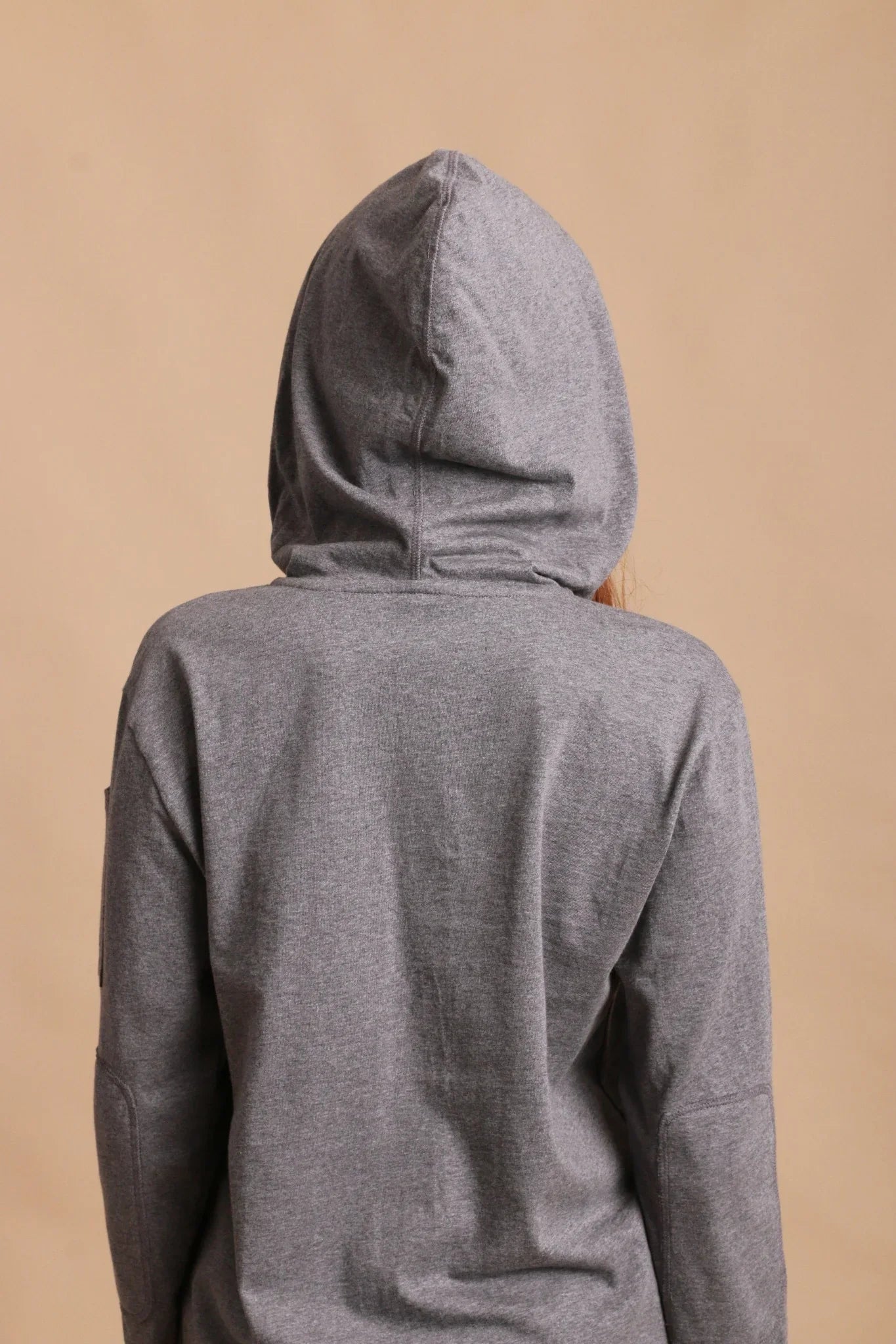 Back view of a person wearing a gray hypoallergenic cotton hoodie from Cottonique