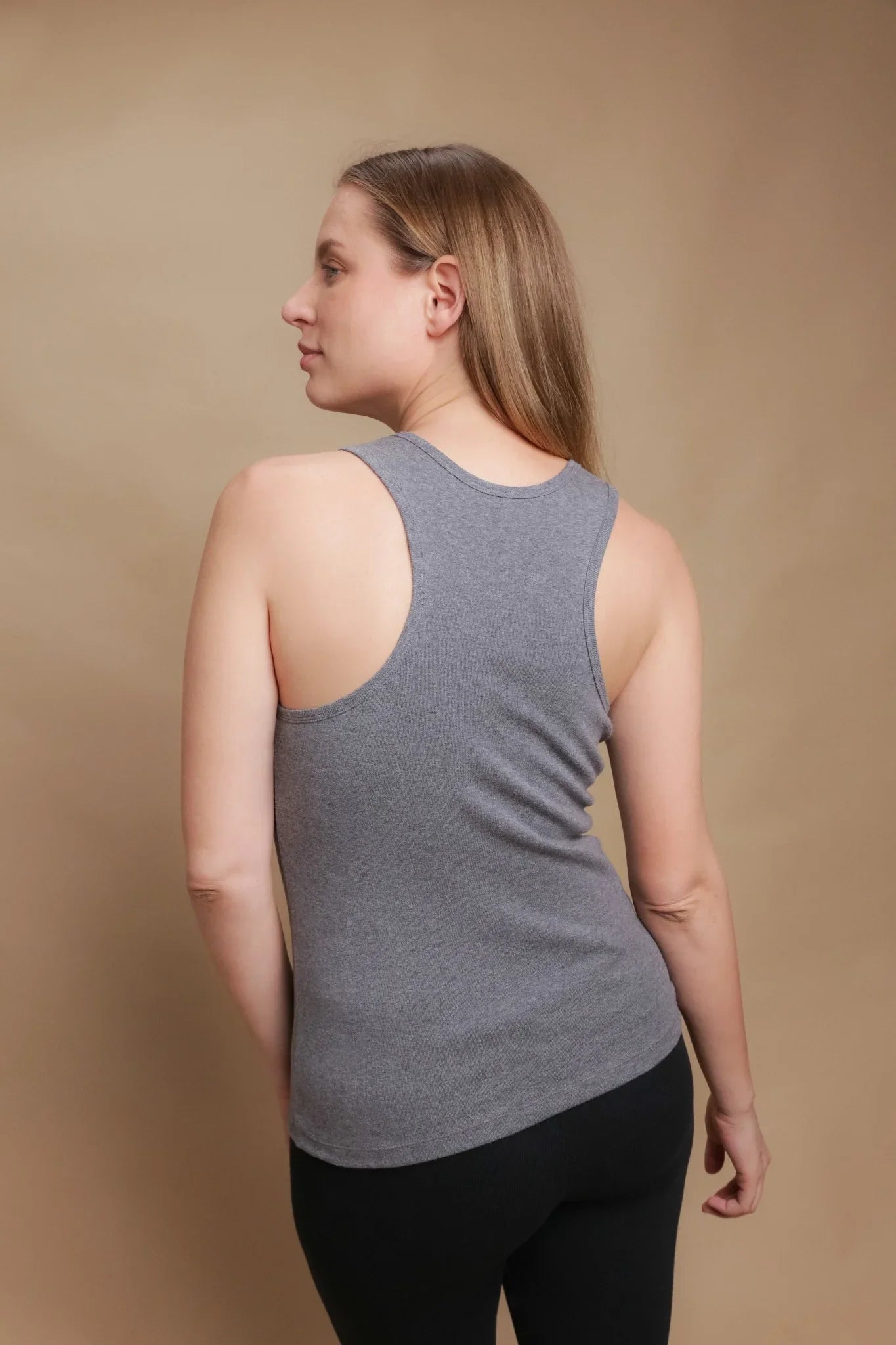 Woman wearing allergy-free gray cotton tank top by Cottonique, back view