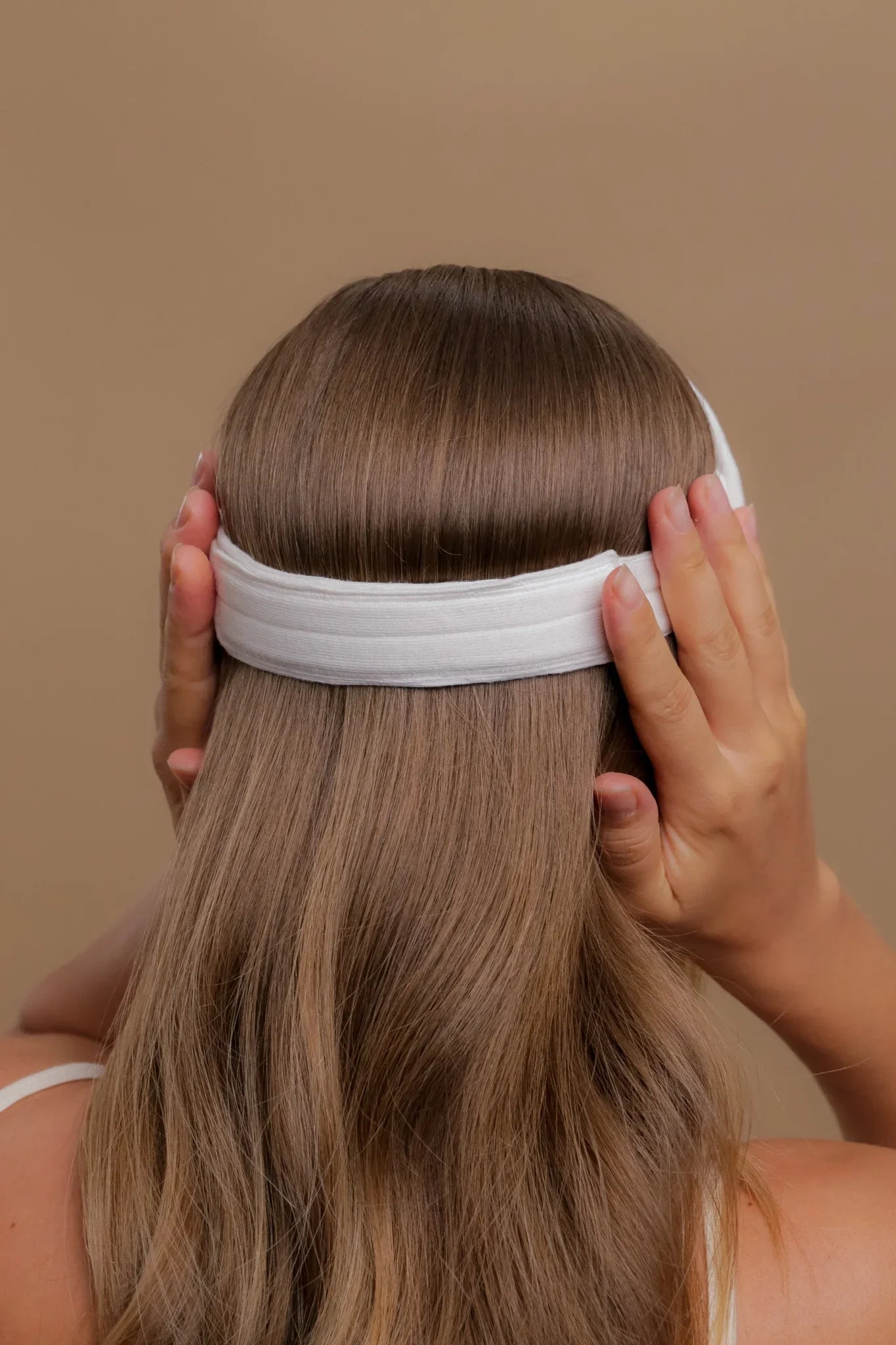 Woman wearing white hypoallergenic cotton headband, back view, Cottonique allergy-free apparel