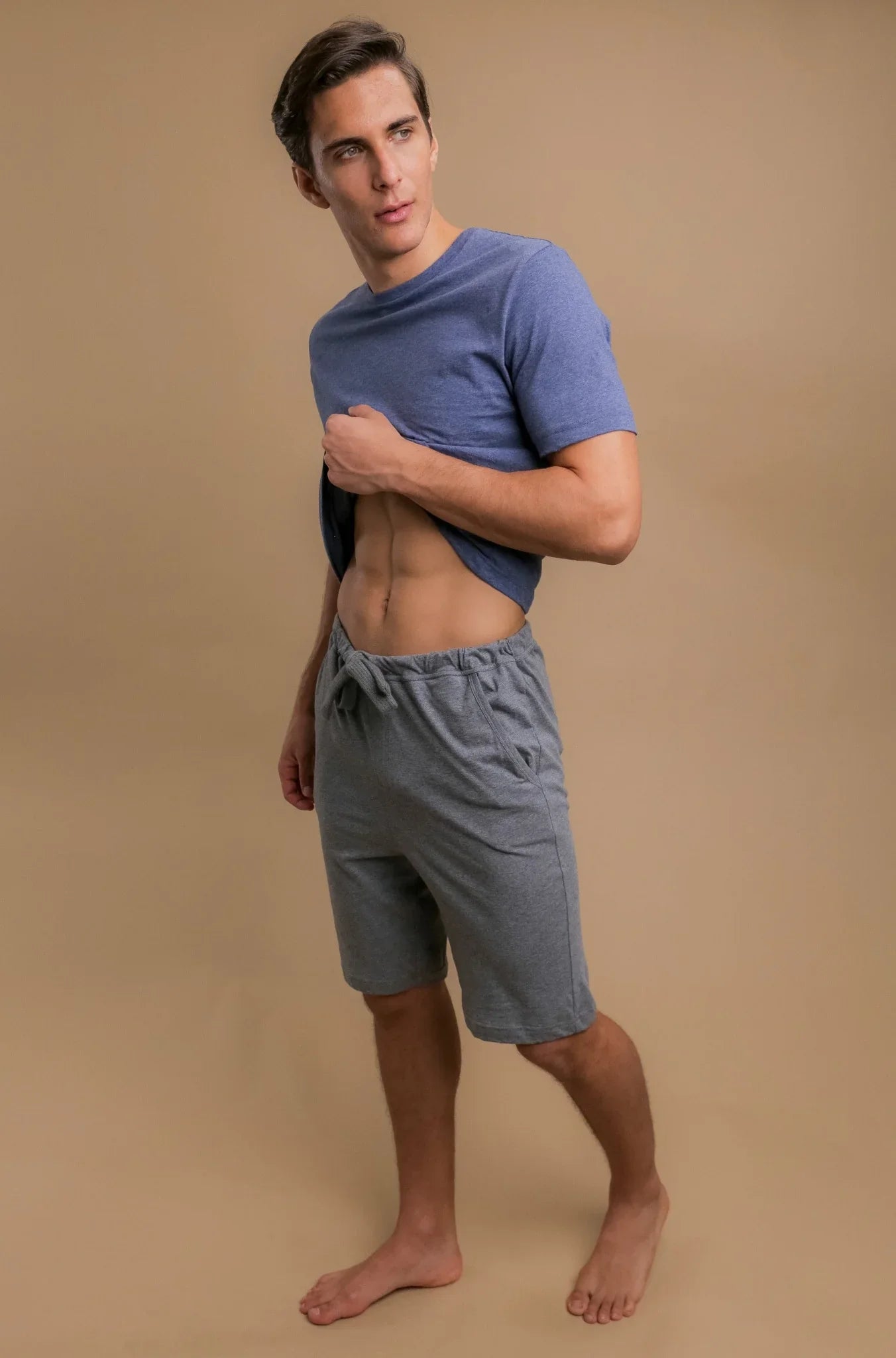 Man wearing blue hypoallergenic T-shirt and gray allergy-free shorts from Cottonique